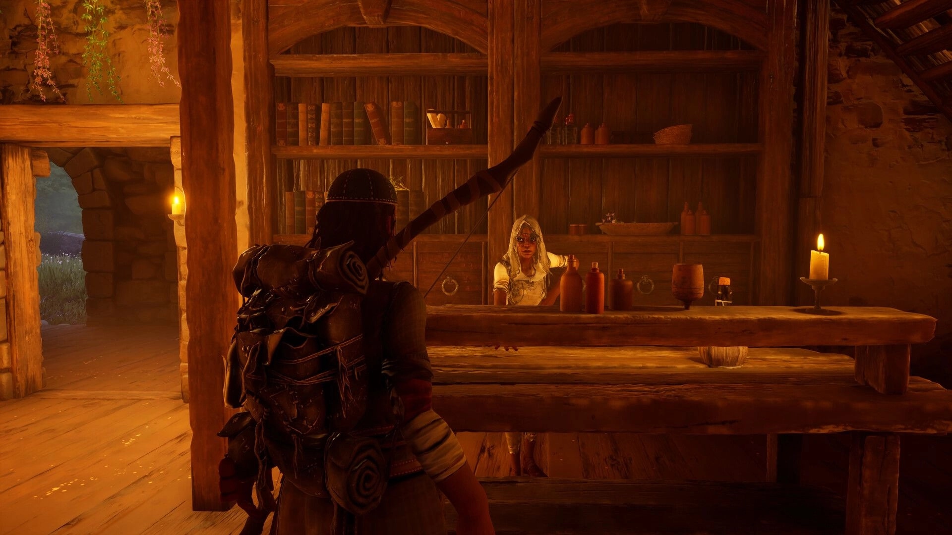 Wyldheart: Player speaks to a hooded shopkeeper behind a candlelit counter in a rustic tavern.