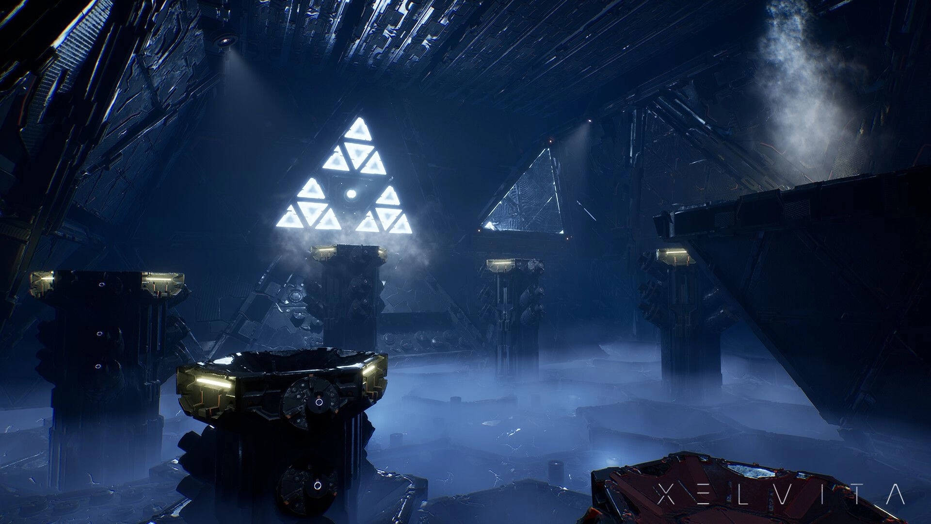 XELVITA: Misty sci-fi chamber with glowing triangle symbols and tall machinery pillars under spotlights.