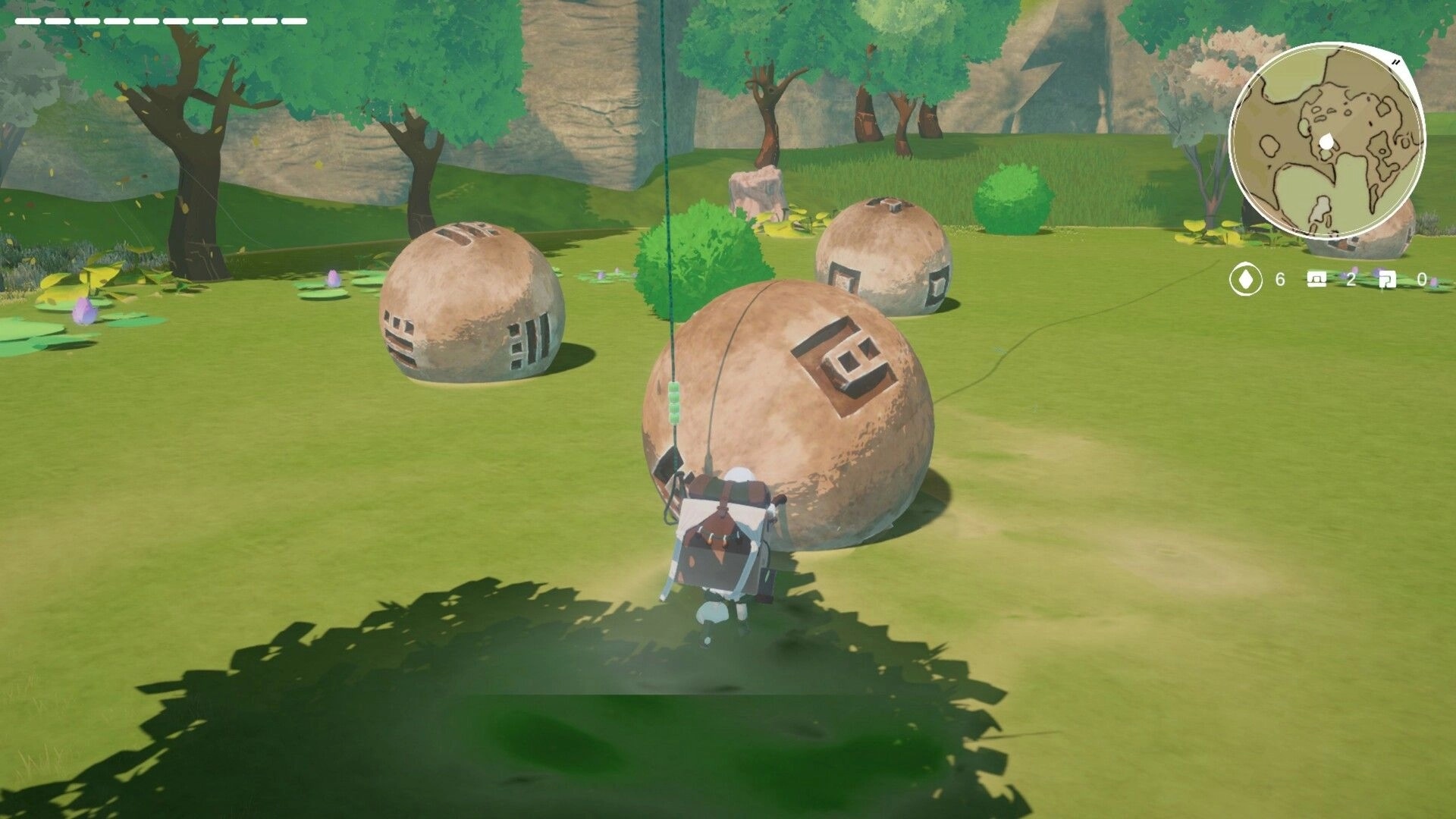 YARETA: Player using Skybound Rope near large stone orbs in a grassy, tree-filled area with mini-map.