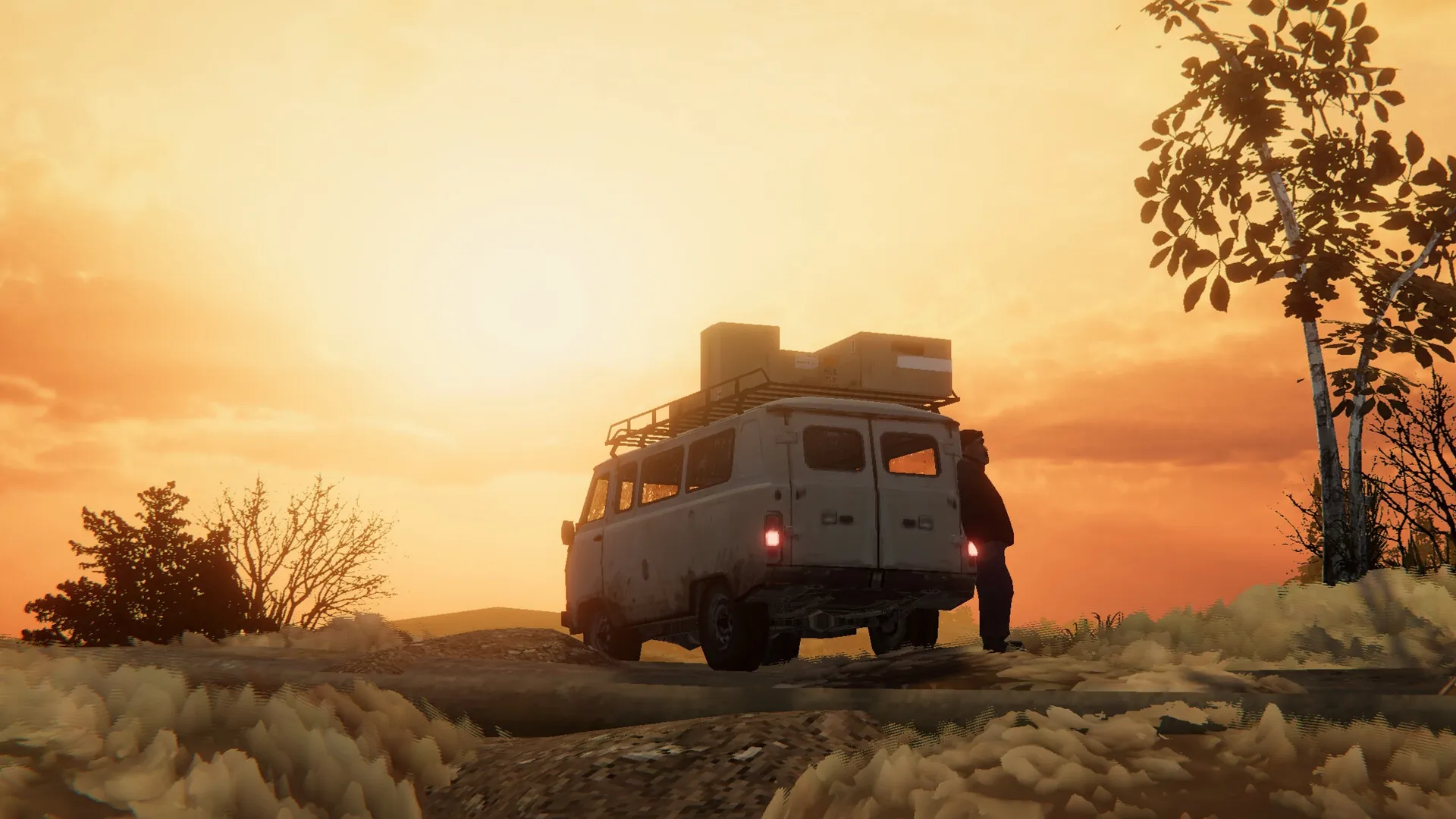 Zarya: Driver standing by loaded van at sunset on a rural road, silhouetted against an orange sky
