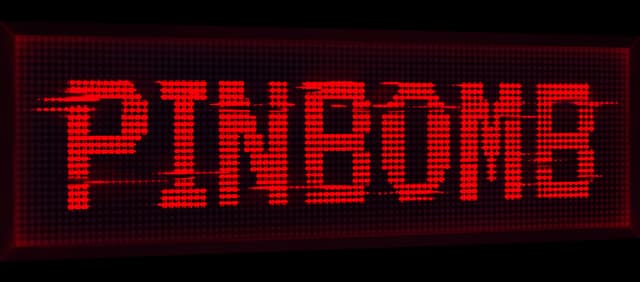 PINBOMB: Red dot-matrix letters with scanline breaks on a beveled display panel.