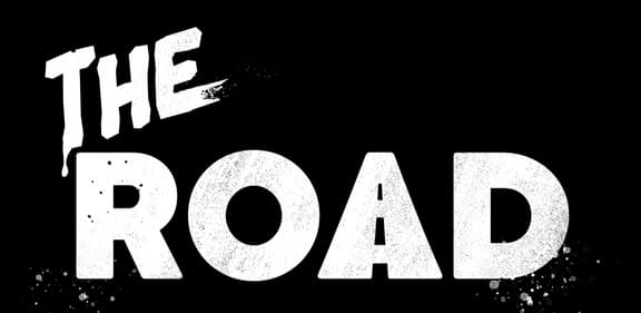 The Road: bold distressed white lettering, drippy “THE” and gritty glitch specks.